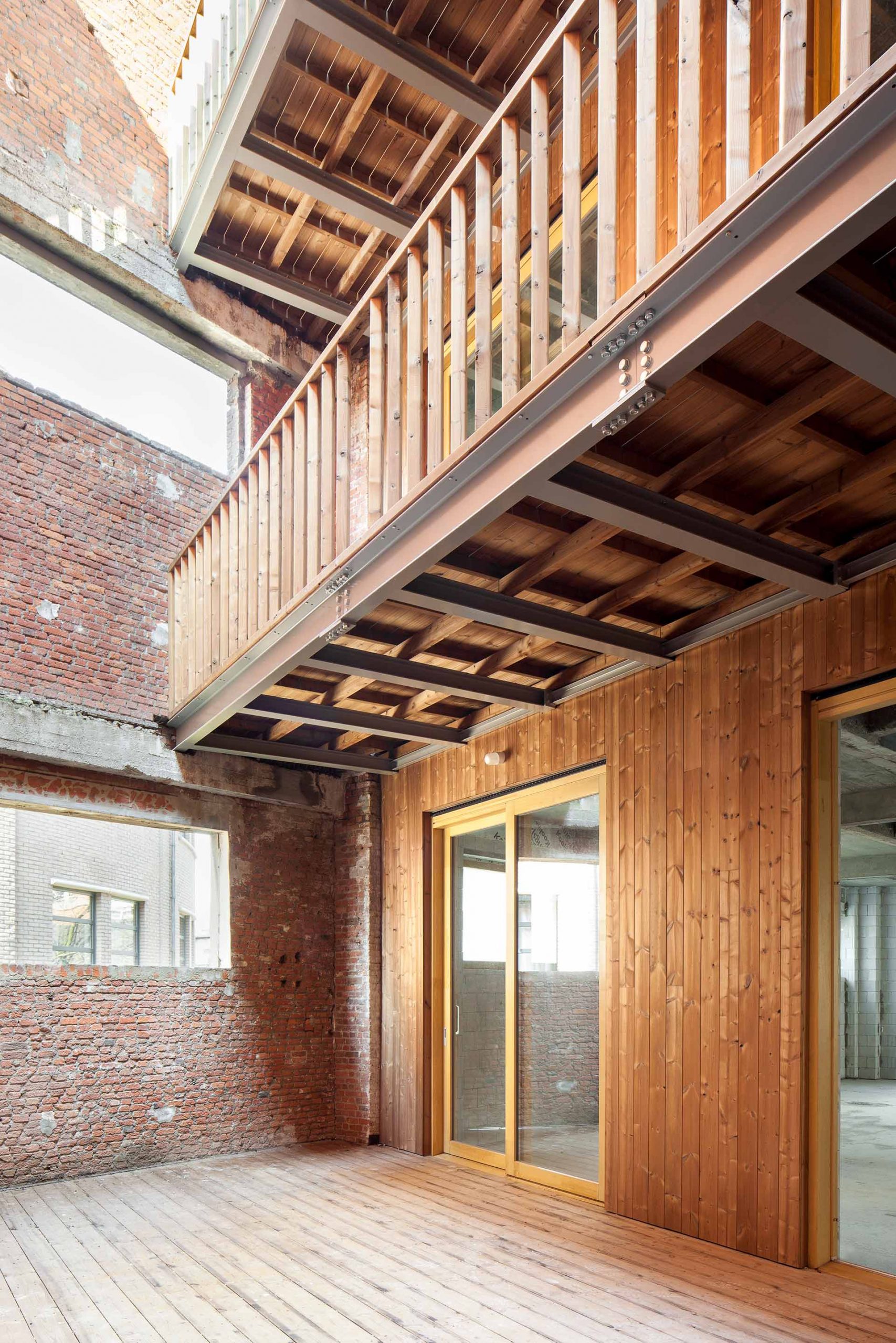 photograph showing a building with wooden walls and a balcony