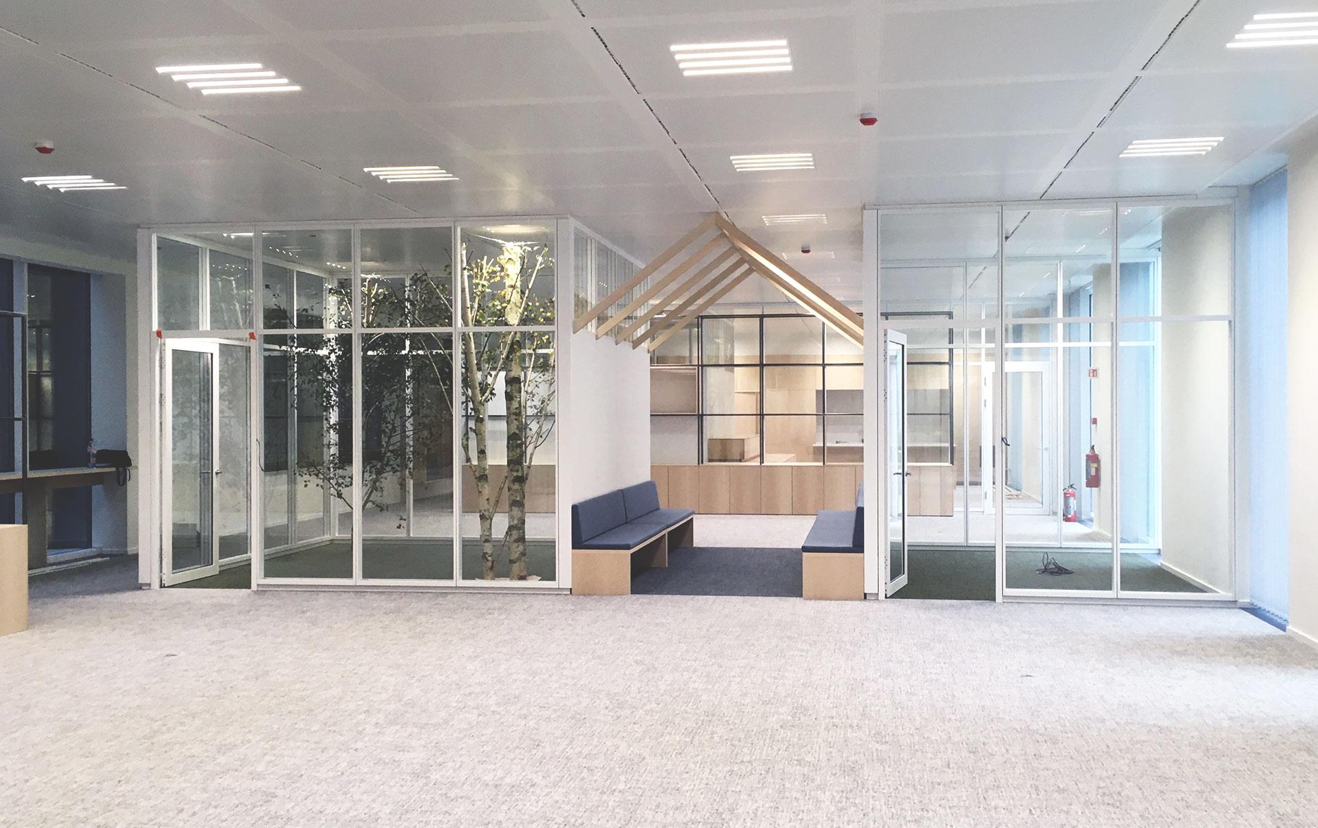 interior of an office building showing a glass cubicle with benches-(c)an vanderhoydonck&Stramien