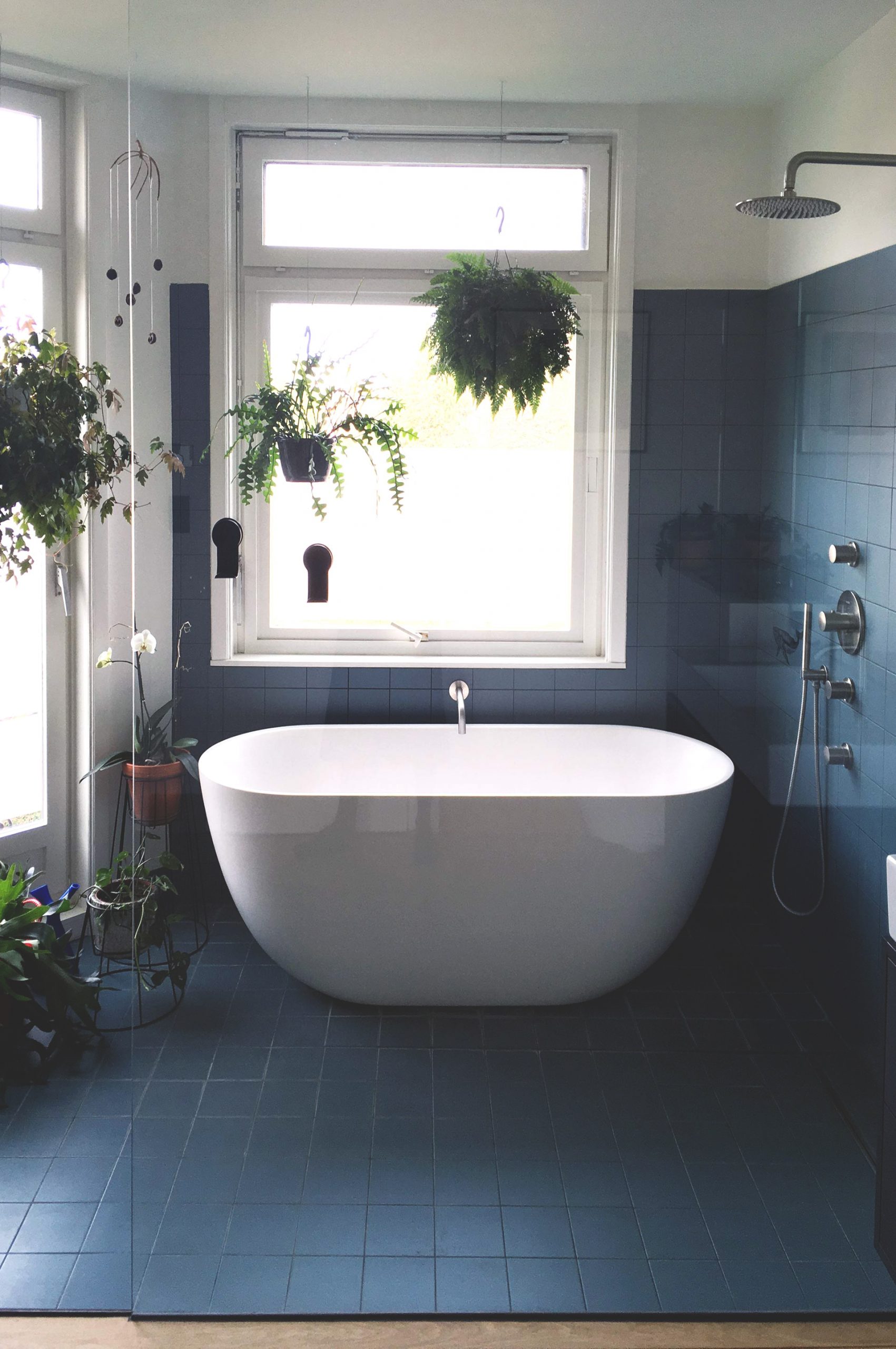 photograph of a bathtub shower combination with blue tiles-(c) an vanderhoydonck