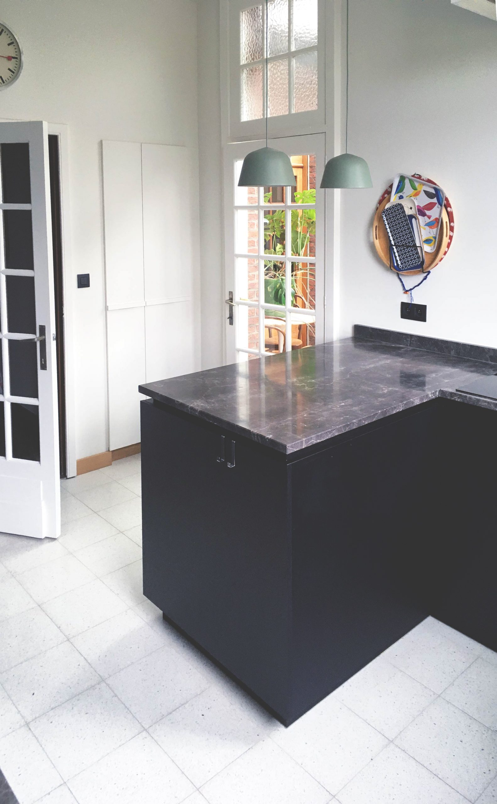 photograph showing kitchen with black furniture-(c) An Vanderhoydonck